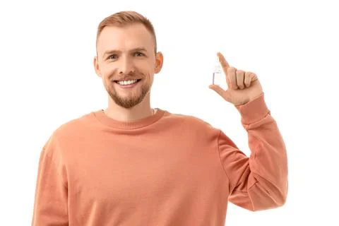 Young man with eye drops on white background Stock Photos