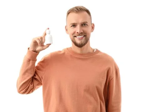 Young man with eye drops on white background Stock Photos