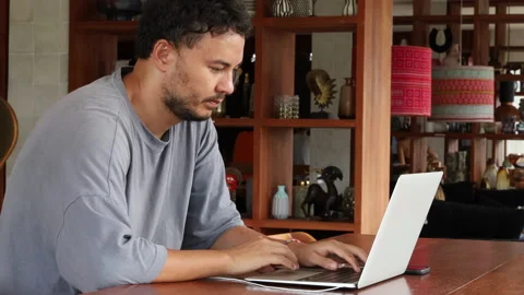 Young man with face mask back at work in after lockdown Stock Footage 161776199