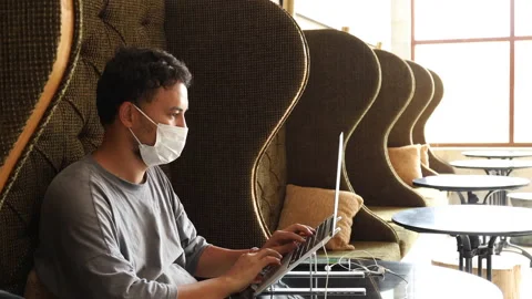 Young man with face mask back at work in after lockdown. Stock Footage 161776706