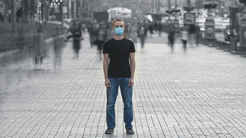 The young man with face mask stands in the crowded street. time lapse Stock Footage 119891891