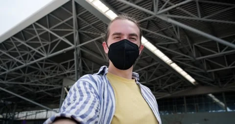 Young man with face mask taking selfie at the airport. Stock Footage 154000129