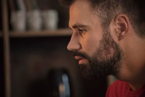 Young man face portrait with beard who sad and looking forward Stock Photos