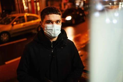 Young man with facemasks shopping outside in the city Stock Photos