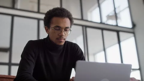 Young man facing issues while working on laptop Stock Footage 300561869