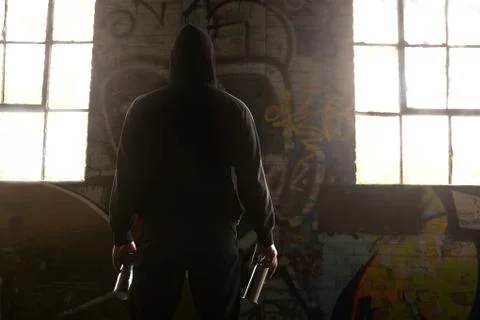 Young man facing a wall and ready to do a graffiti Stock Photos