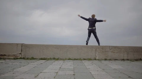 Young man falls down a concrete border 스톡 동영상 109554726