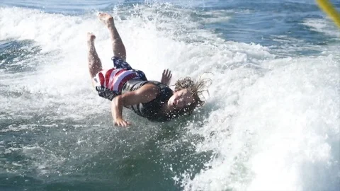 Young Man Falls Hard While Wake Surfing Stock Footage