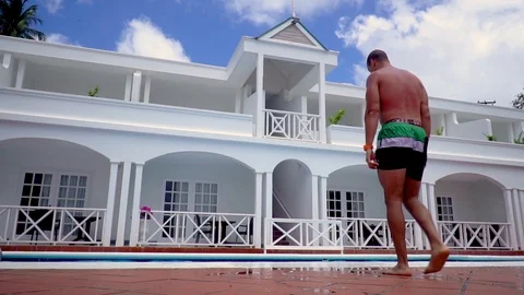 Young man falls into swimming pool Stock Footage 109099802
