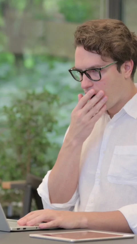 Young Man Feeling Shocked While Using Laptop in Modern Office, Vertical Video Stock Footage 340032061