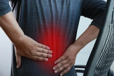 Young man Feeling suffering  Lower back pain  Pain relief concept Fotos Stock
