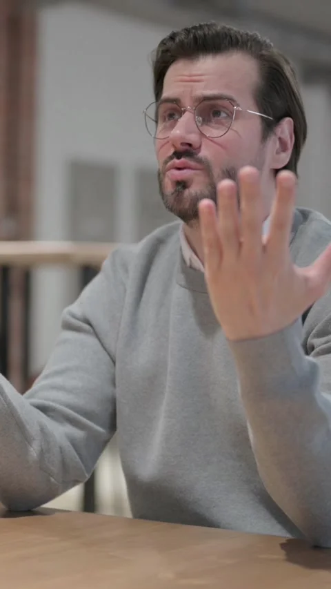 Young Man Feeling Worried while Sitting in Café, Vertical Video Stock Footage 339581025