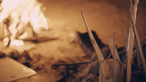 Young man feels cold and warms up himself by bonfire Stock Footage 91031419