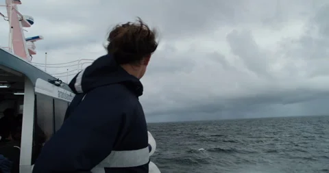 Young man on a ferry in a rough windy weather in Atlantic Ocean on the route Stock Footage 253821361