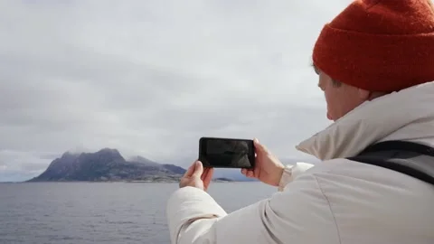 Young Man on a Ferry Taking Panorama Photo of Sea with Mobile Phone. Stock Footage 219487464