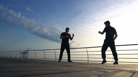 Young man fight training against sunrise in slow motion Video stock 77720544