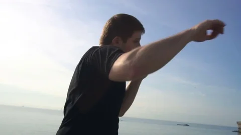 Young man fight training against sunrise in slow motion Stock Footage 77784589
