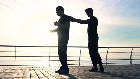 Young man fight training against sunrise in slow motion Stock Footage 78107583