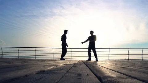 Young man fight training against sunrise in slow motion Stock Footage