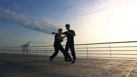 Young man fight training against sunrise in slow motion Stock Footage