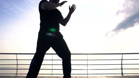 Young man fight training against sunrise in slow motion Stock Footage 78143167