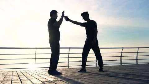 Young man fight training against sunrise in slow motion Stock Footage 79173531