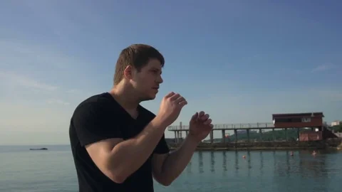 Young man fight training against sunrise in slow motion Stock Footage 79178233
