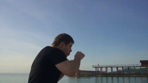 Young man fight training against sunrise in slow motion Stock Footage 79178696