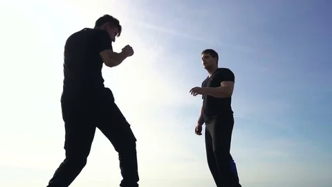Young man fight training against sunrise in slow motion Stock Footage 79180633