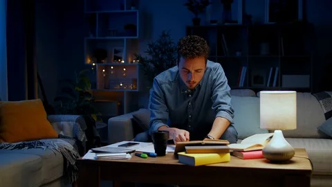 Young man finds a solution to a problem during his nightly studies Stock Footage 120078514