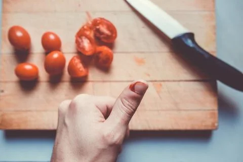 Young man finger cut while cooking a lunch, bleeding, cooking injury Stock Photos