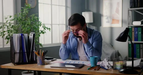 Young man finished work at home office. Tired businessman closing laptop taking Stock Footage 151103044