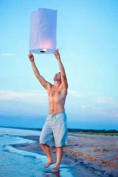 A young man with a fire lantern Stock Photos