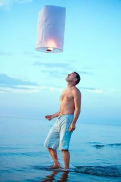 A young man with a fire lantern Stock Photos