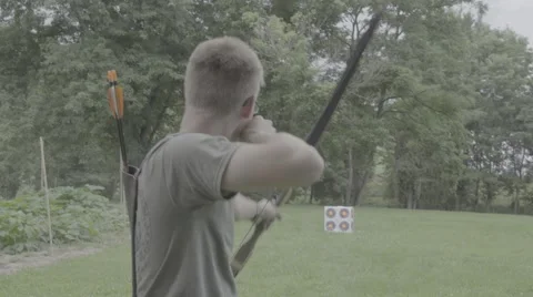 Young Man Fires Arrow at Target Stock Footage 65259904