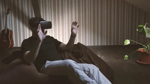 Young man first time experiencing virtual reality glasses Stock Footage 74367822
