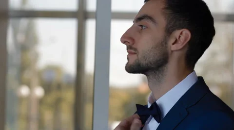 Young man fix his bow tie Stock Footage 61652786