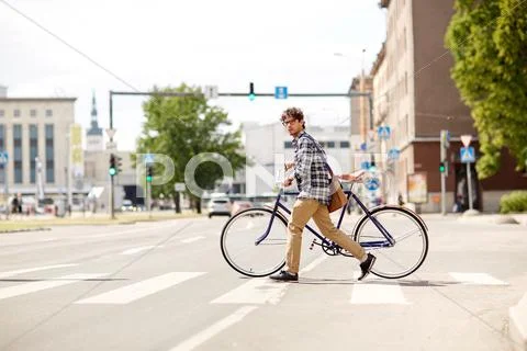 Young man with fixed gear bicycle on crosswalk Stock Photos