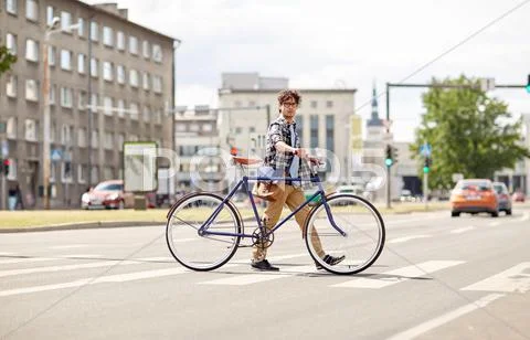 Young man with fixed gear bicycle on crosswalk Stock Photos