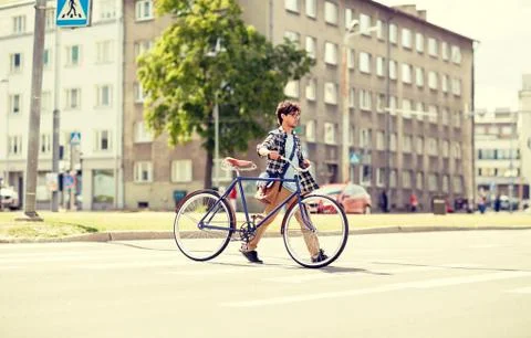 Young man with fixed gear bicycle on crosswalk Stock Photos