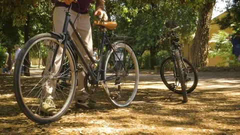 Young Man Fixing Bike tire in villa borghese Park in Rome on sunny summer day Stock Footage 84136653