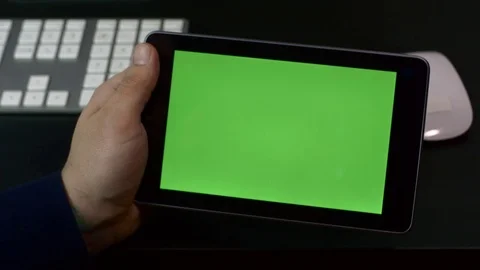 Young Man Flipping Through Pages On Internet, Tablet Computer with Green Screen Stock Footage 73784467