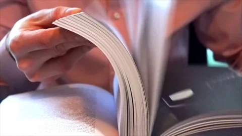 Young man flips pages and find money Stock Footage 84778030