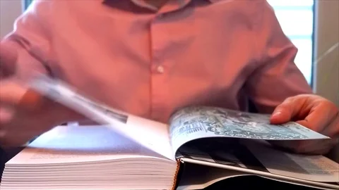 Young man flips pages in his book Stock Footage 84834164