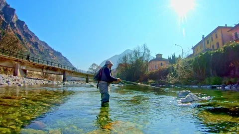 Young man flyfishing after work Stock Footage 107133026