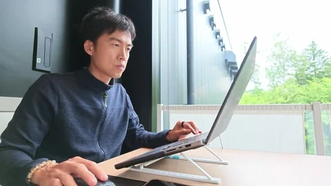 Young man focuses on laptop work Stock Footage 340238550