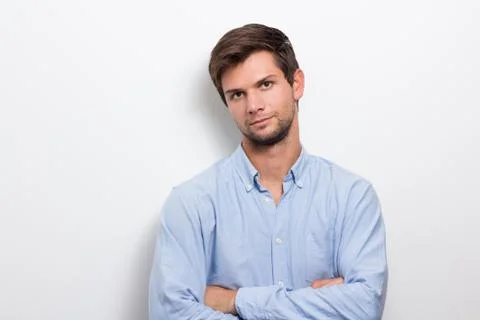 Young man with folded arms looking serious Stock Photos