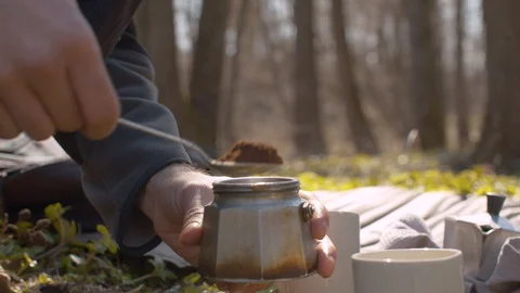 Young man in the forest preparing coffee Stock Footage 129075513