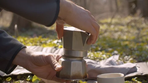 Young man in the forest preparing coffee Stock Footage 129076151