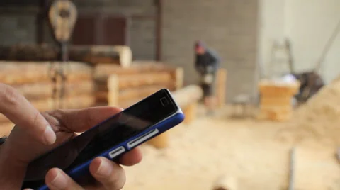 Young man forestry engineer touch phone in front of wood Stock Footage 65319743